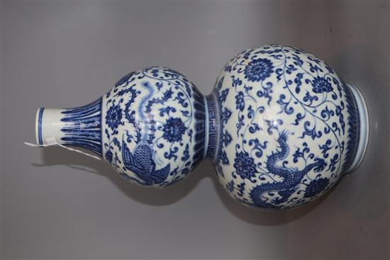A Chinese blue and white dragon and phoenix double gourd vase , Qianlong mark but late 19th/early 20th century, H. 35.cm